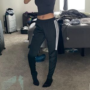Black adidas fitted joggers with white stripes and adidas logo